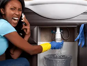 Emergency plumbing repair for a leaking sink drain under a bathroom vanity in Scottsdale, AZ