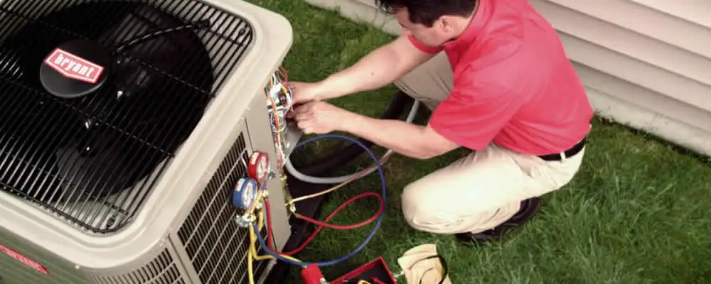 HVAC technician servicing an outdoor air conditioner unit in Scottsdale, AZ