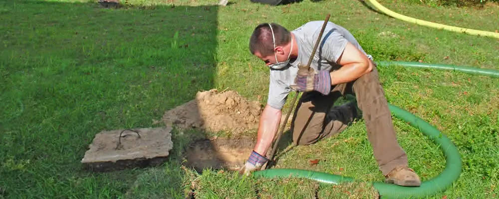 Septic pumping technician servicing a residential septic tank in Scottsdale, AZ